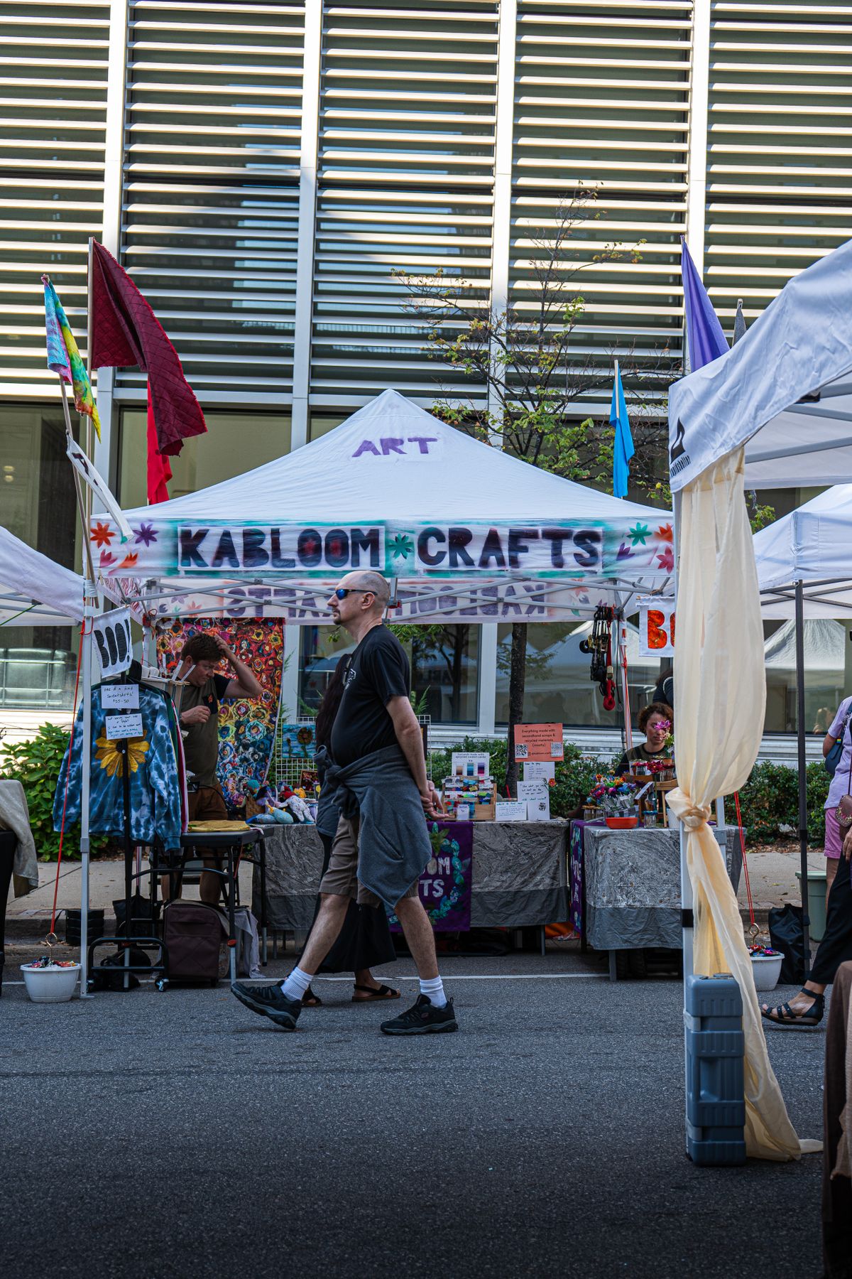 A colorful artisan booth at an outdoor craft fair
