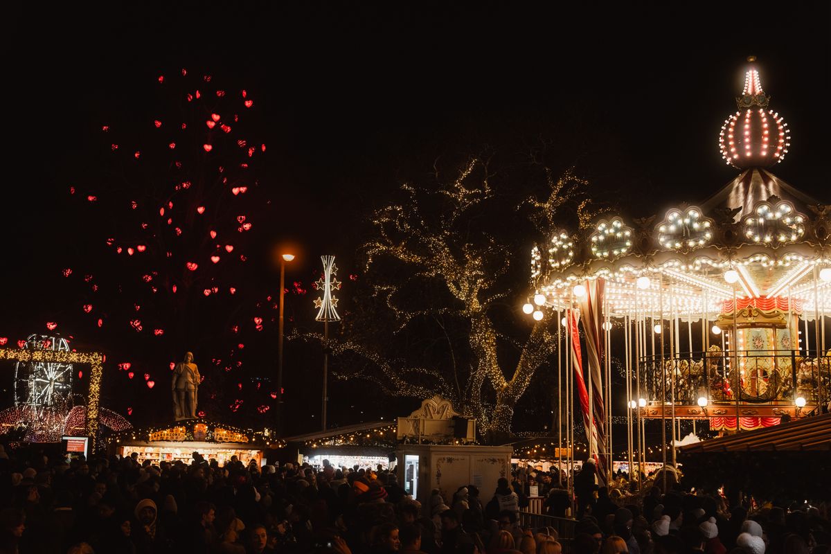 A holiday market at night with festive lights