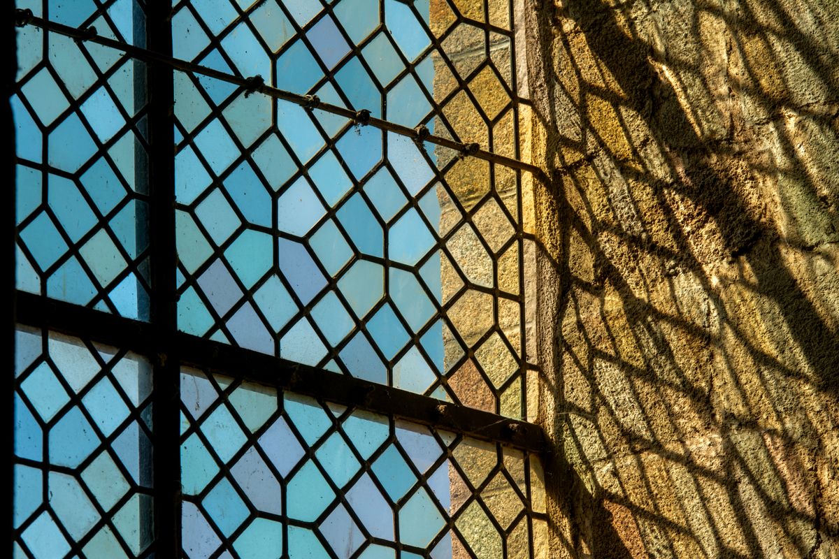 Sunlight shining through a colorful stained glass window